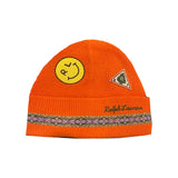 Polo Ralph Lauren orange RL Smiley Patch skullie hat featuring a playful embroidered patch on white fabric.